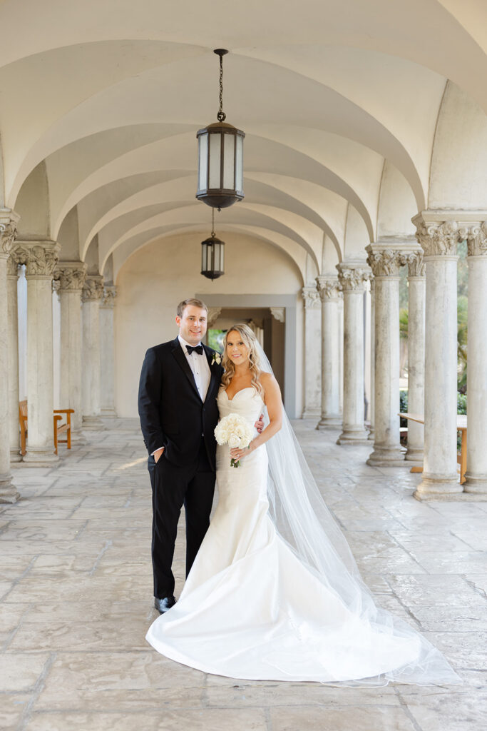 Ben and Kelly standing together in the sunlit colonnade.