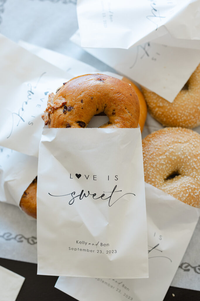 Cookie favors packaged in white bags for wedding guests.