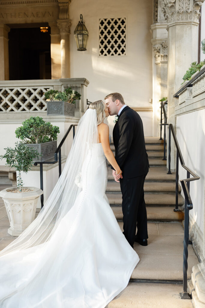 Ben leaning toward Kelly on the church steps.