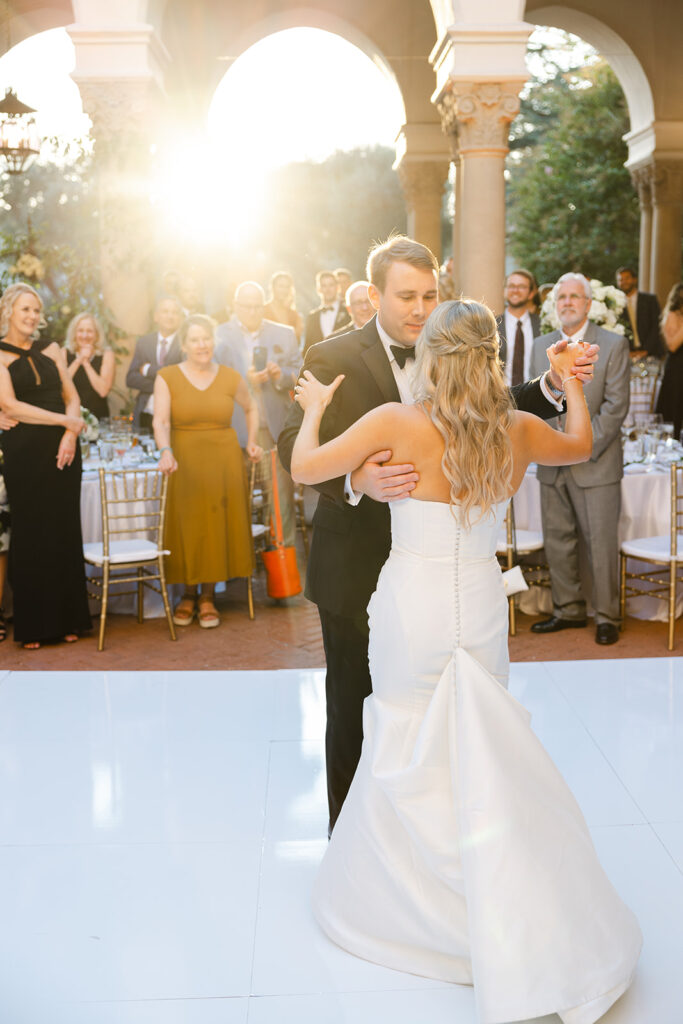 Ben and Kelly sharing a dance surrounded by wedding guests.