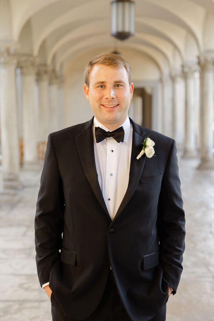 Ben smiling in his tuxedo beneath the colonnade.