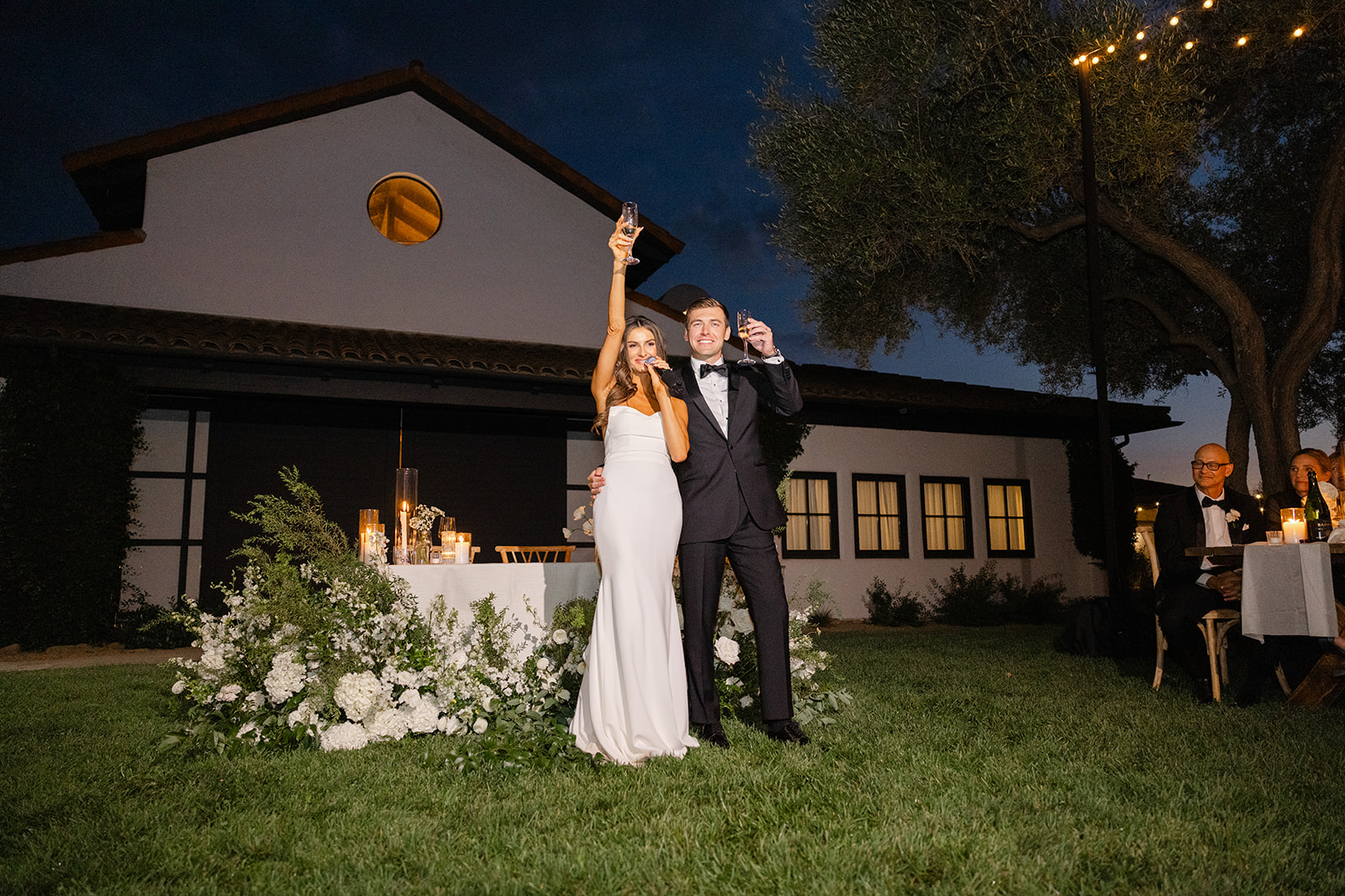Jake and Zoe raising their glasses during the evening reception.