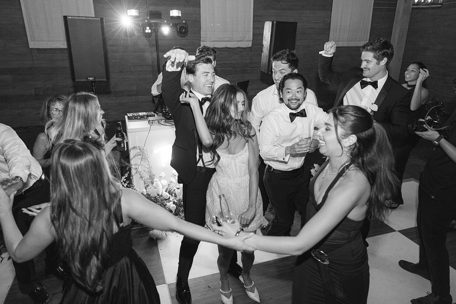 Guests gathered on the dance floor in black-and-white photography.