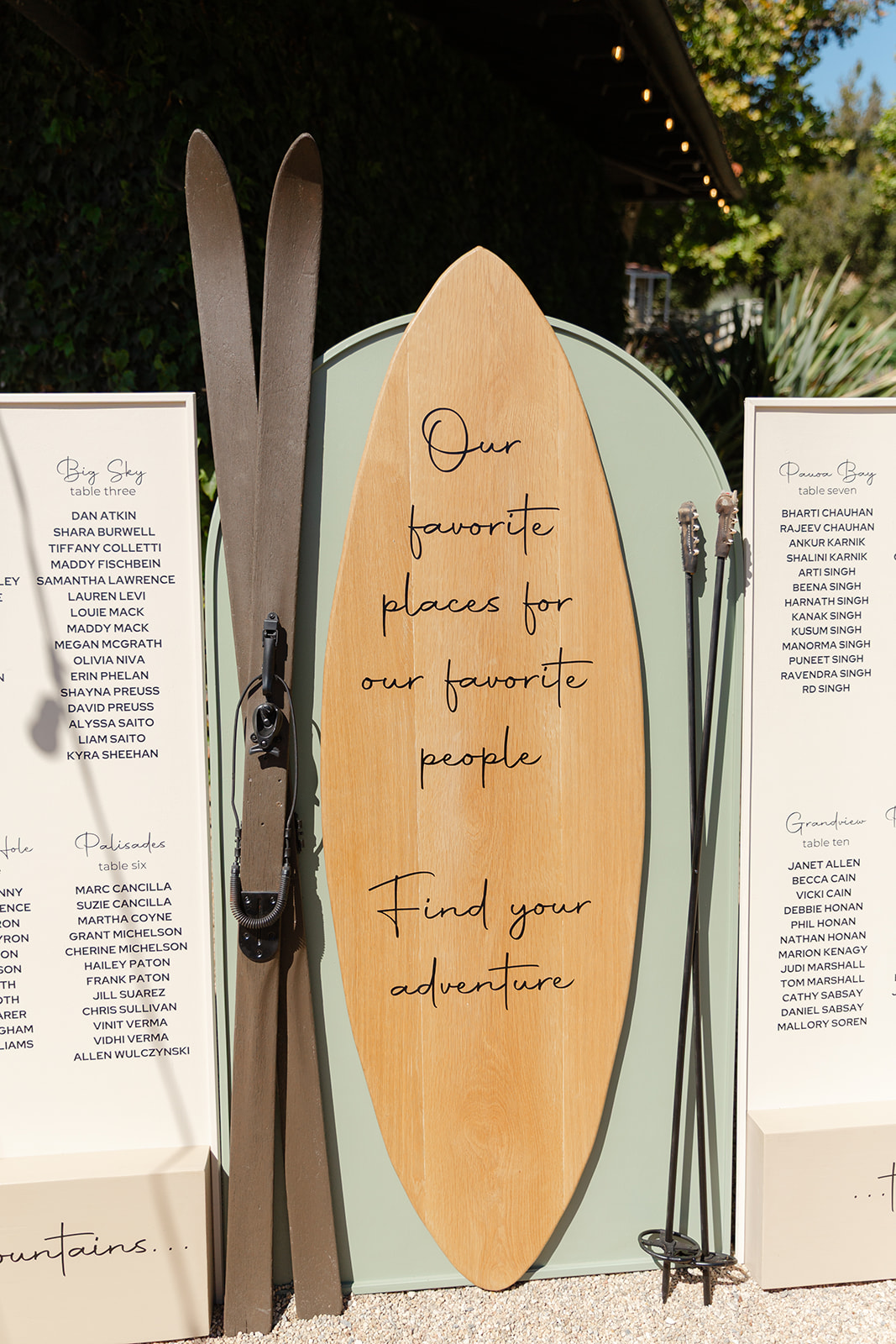 Surfboard-inspired wedding seating chart outside the ranch building.