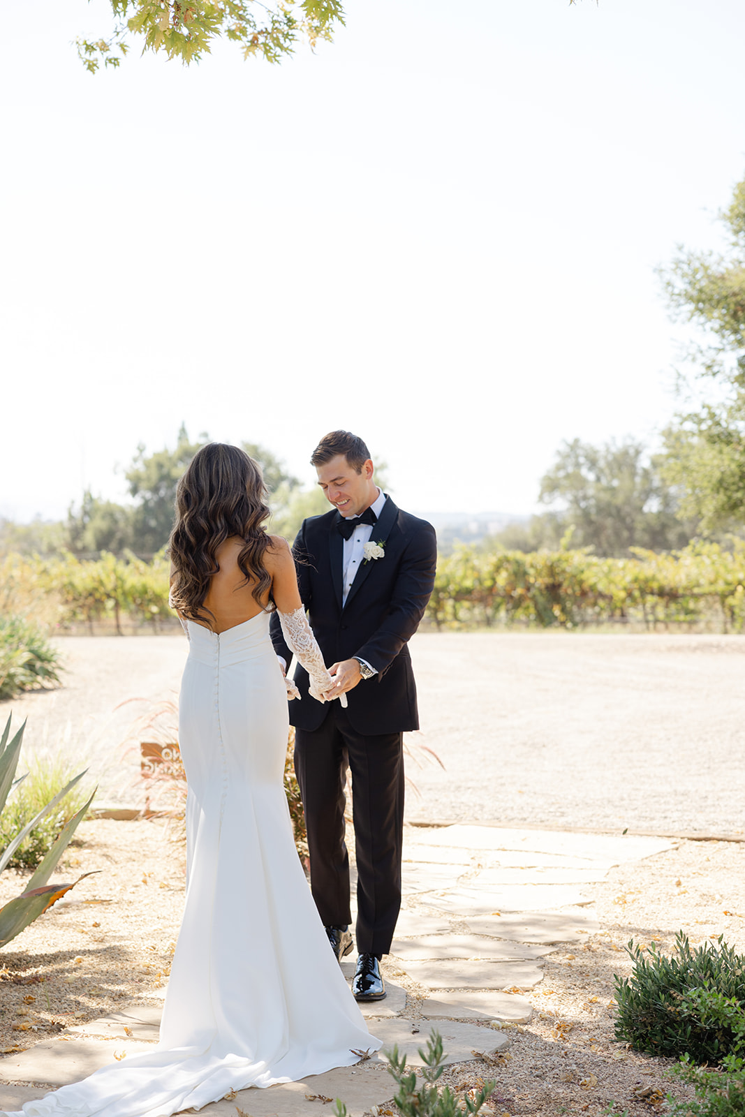 Jake and Zoe holding hands on a garden path.