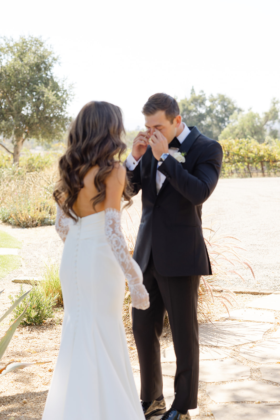 Jake kissing Zoe’s hand during their wedding portraits.