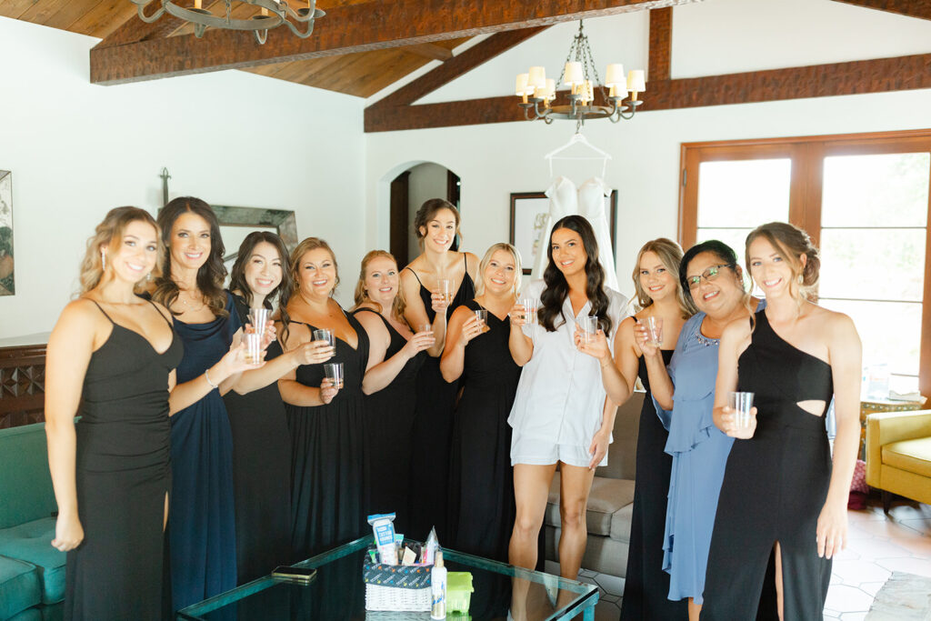 Samantha and her bridesmaids holding champagne glasses before the wedding.