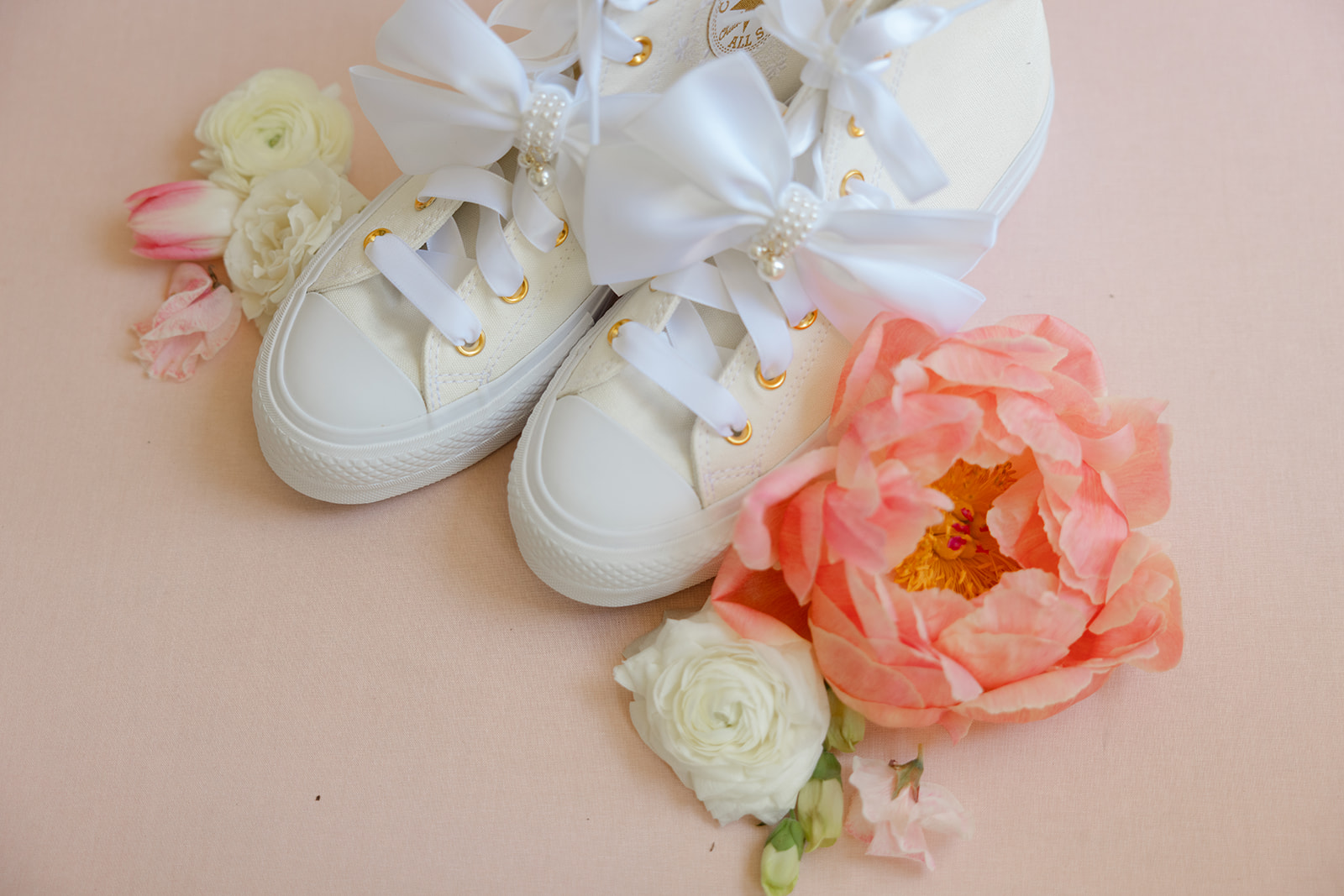 White bridal sneakers with satin bows and peach flowers
