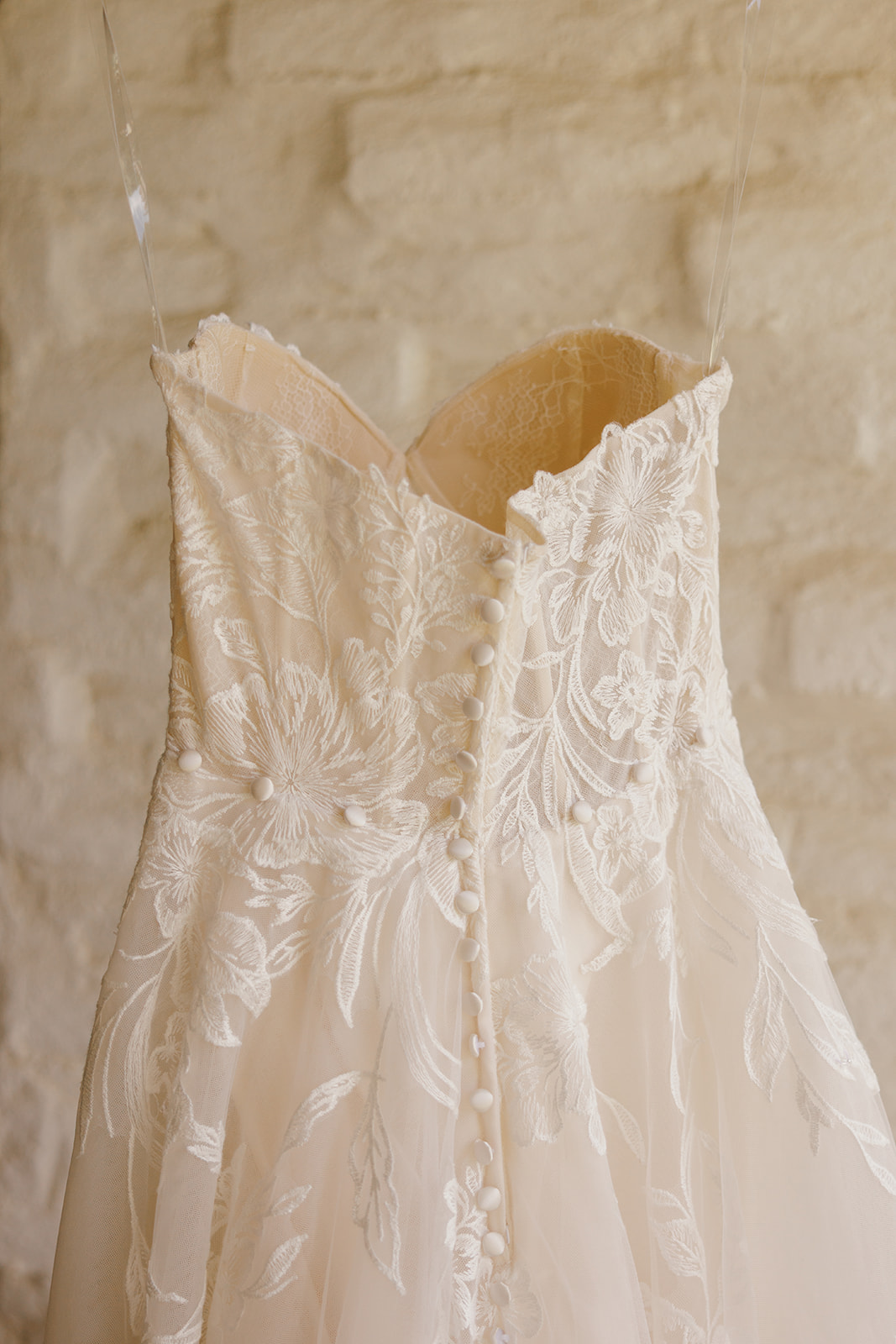 Close-up of floral lace and buttons on Rachel’s wedding gown