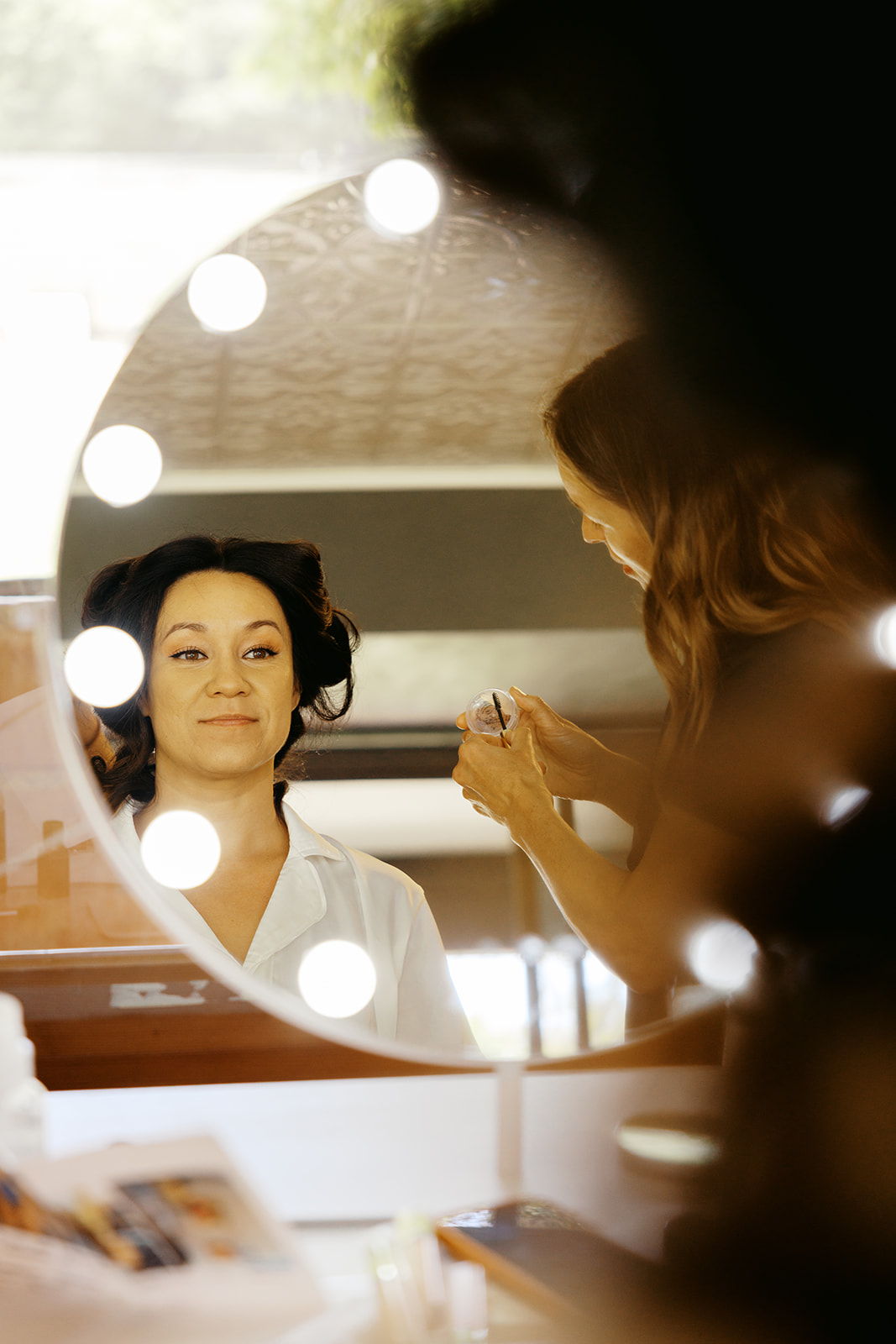 Rachel reflected in a mirror during bridal makeup