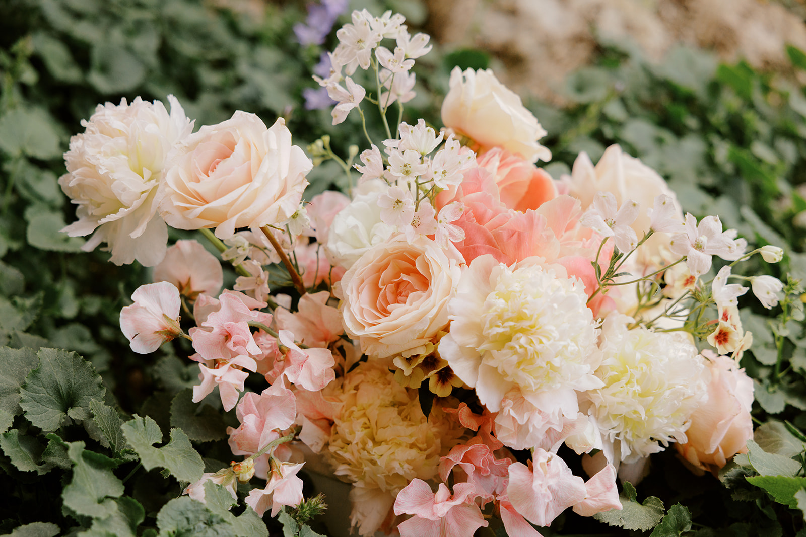 Peach, pink, and white bridal bouquet by Rebel Floral
