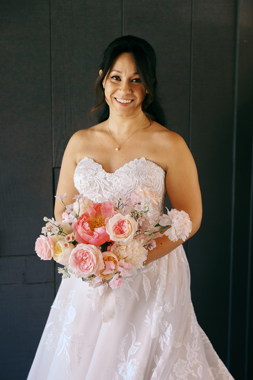 Rachel smiling with her bouquet before the ceremony