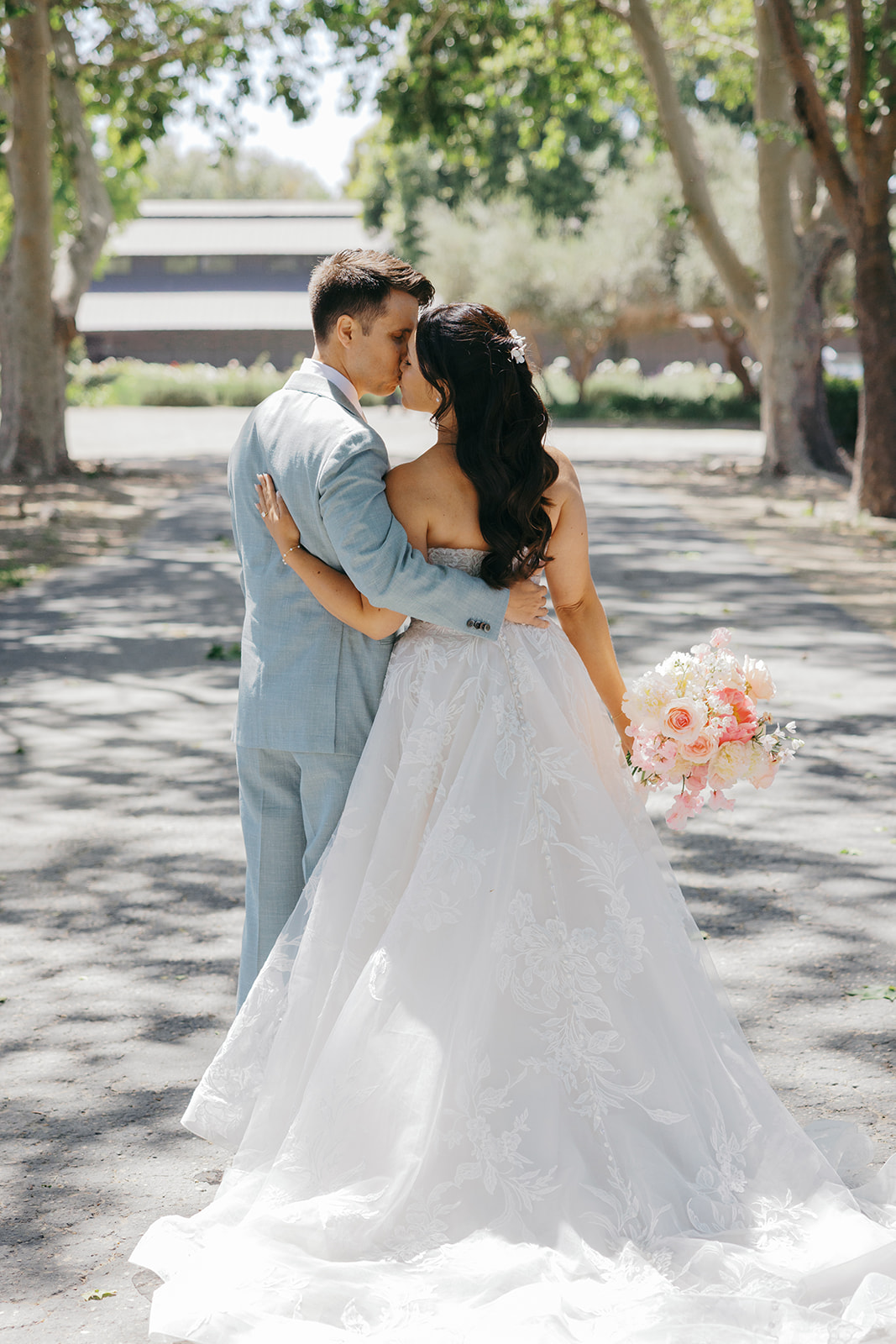 Rachel and Damien embracing along the ranch drive