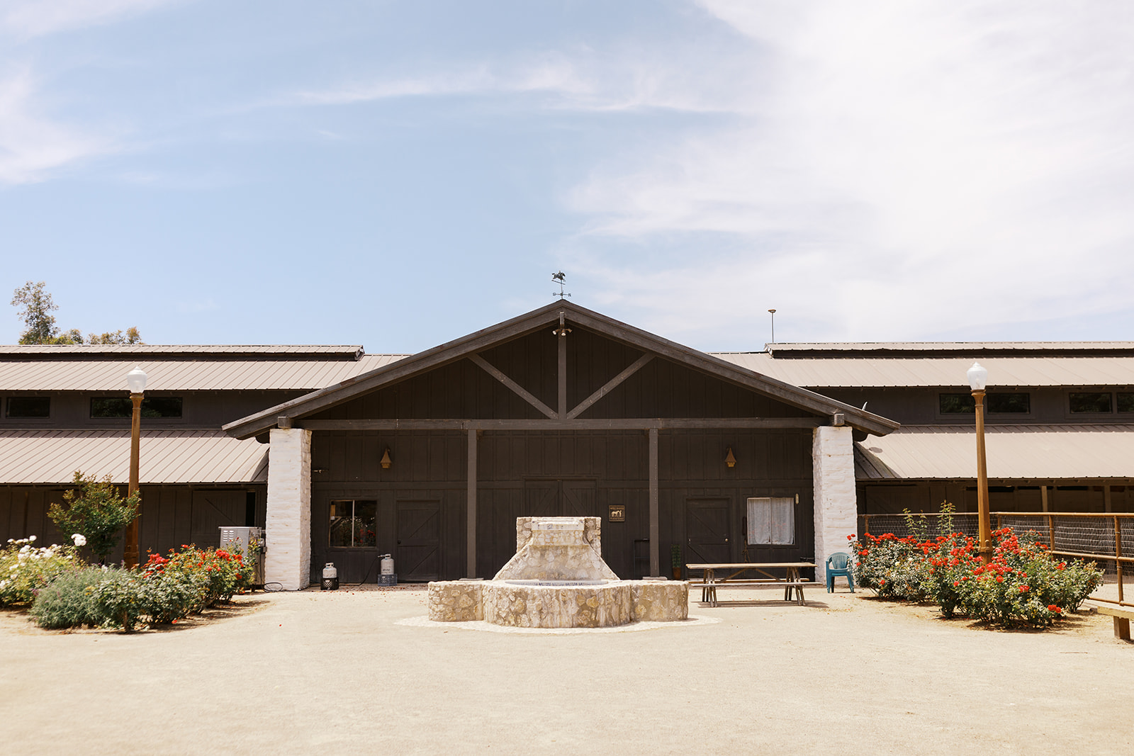 Ranch barn and courtyard beneath a blue sky