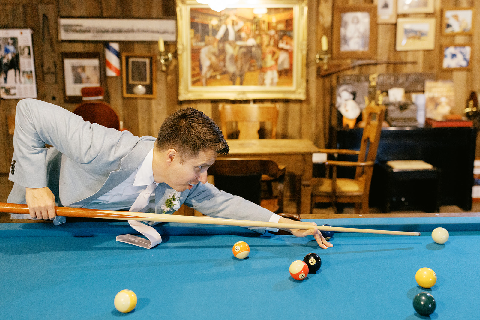 Damien playing pool in the ranch saloon before the wedding