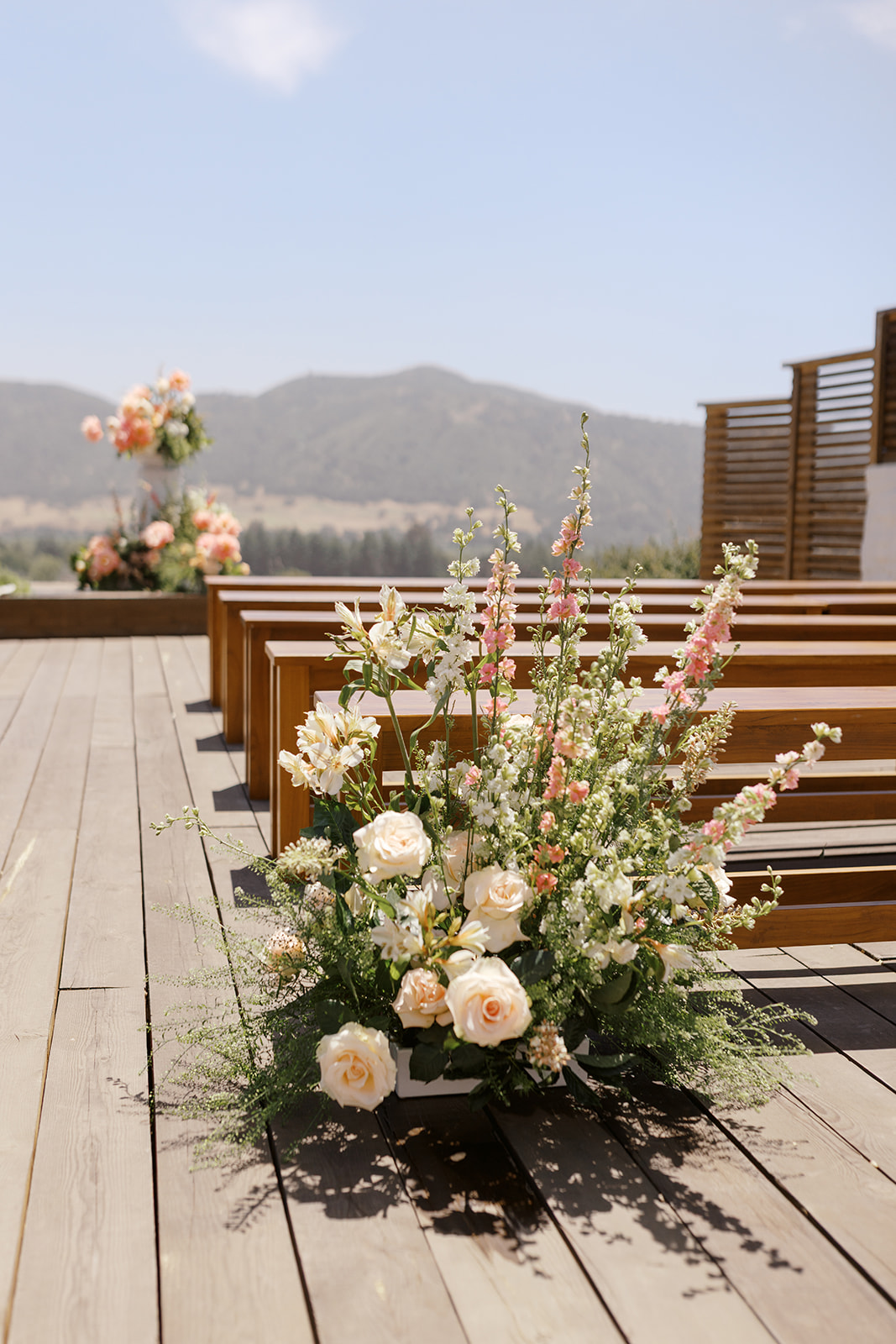 Spring floral arrangement at the entrance to the ceremony aisle