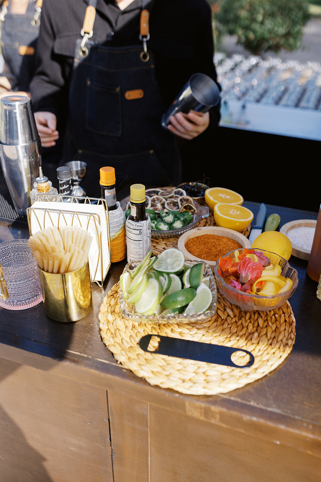 Citrus garnishes and cocktail ingredients arranged at the bar