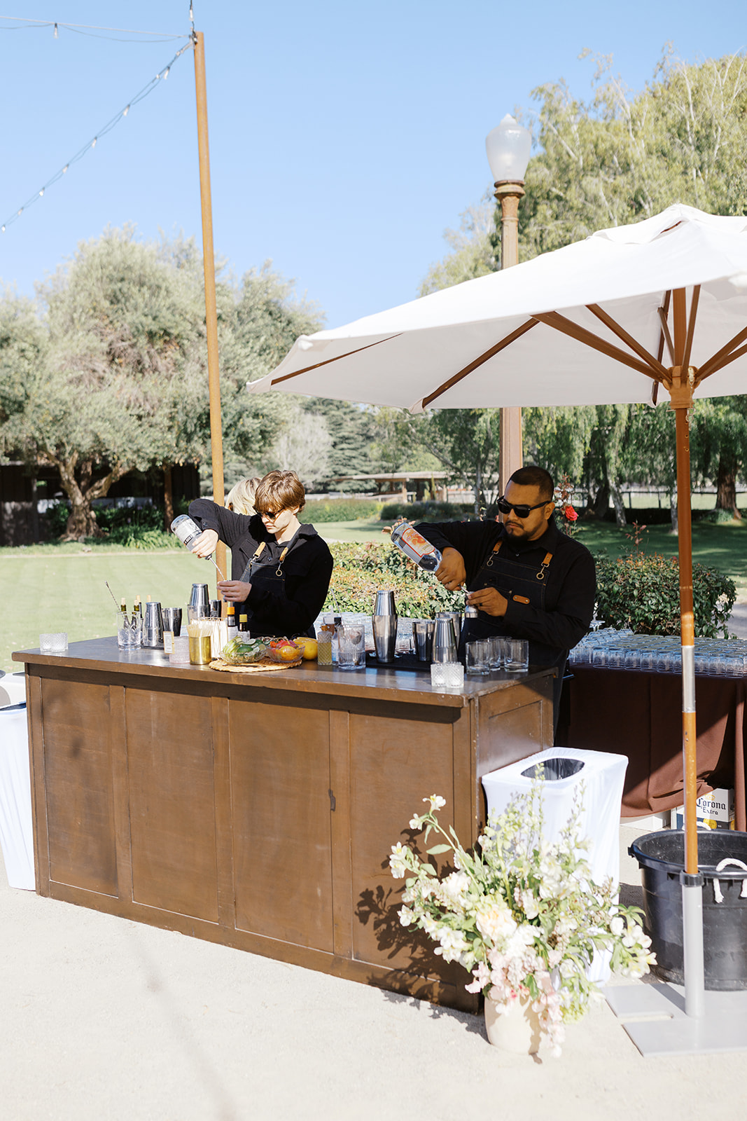 Outdoor cocktail bar beneath a white umbrella