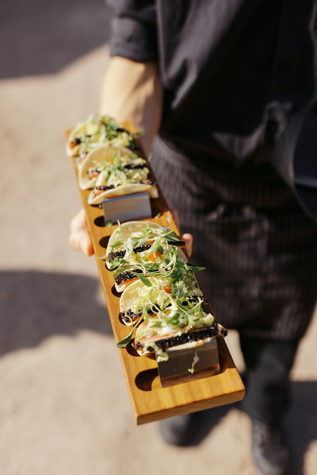 Passed appetizers presented on a wooden serving board