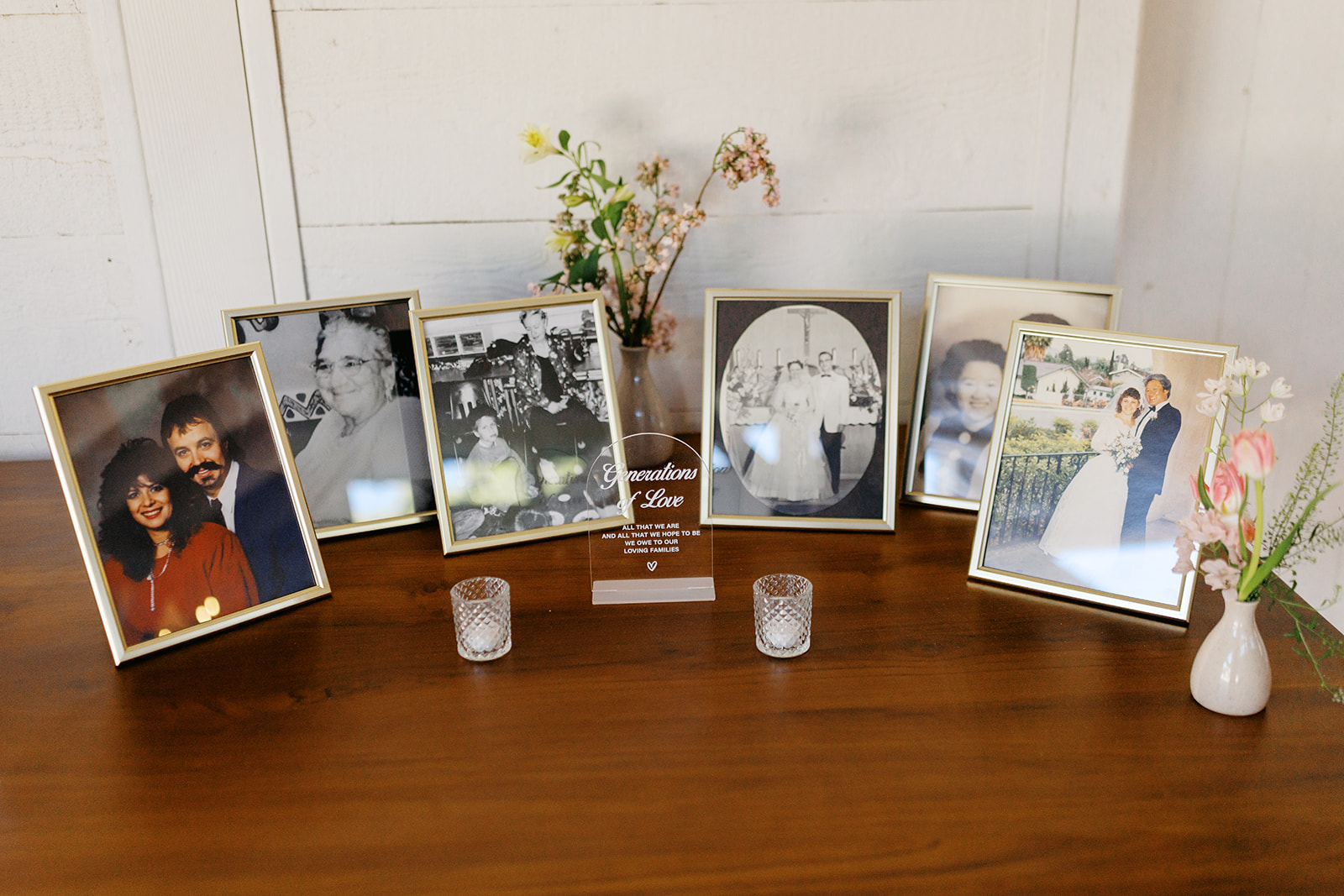 Family wedding photographs displayed on the welcome table