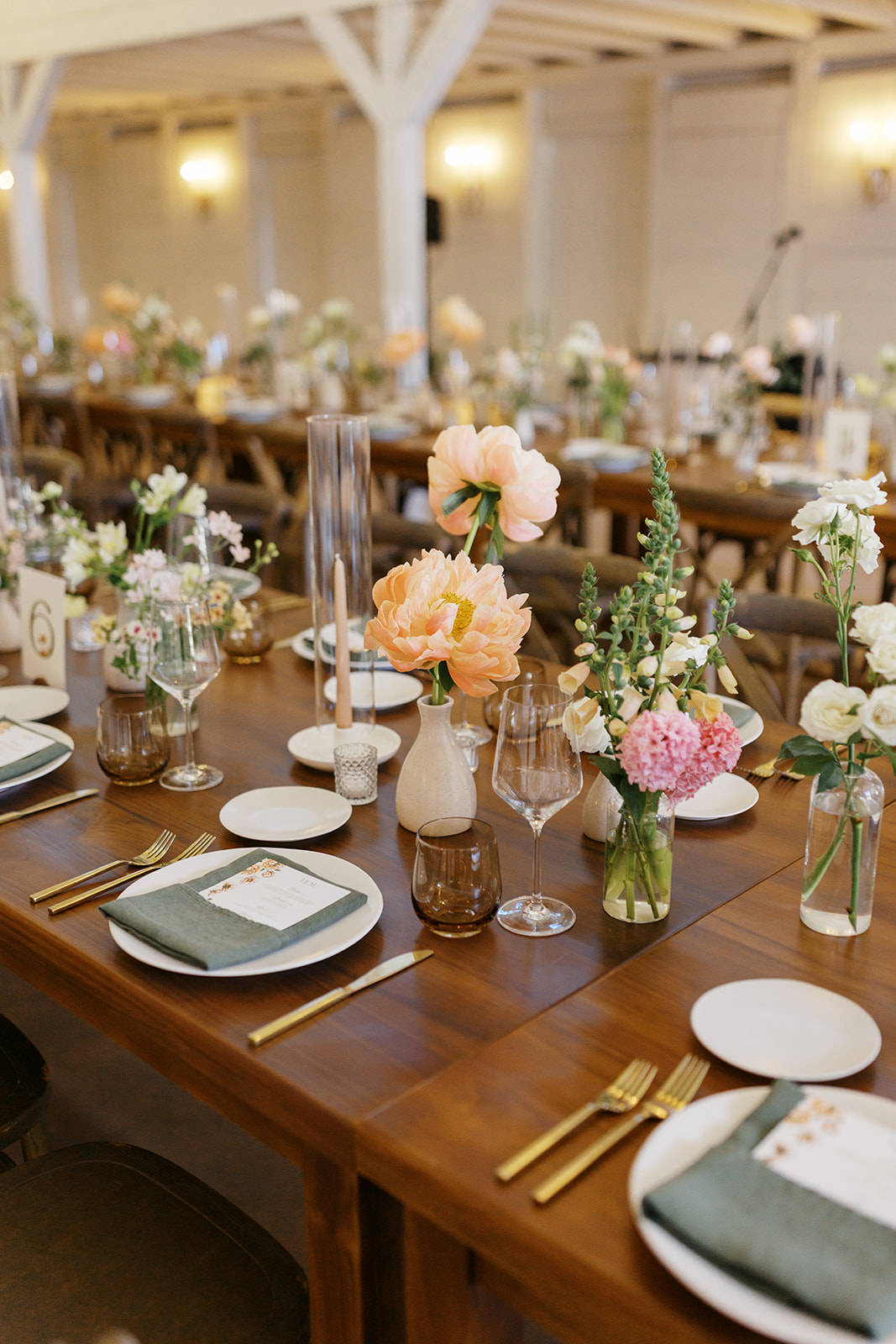 Spring flowers and green napkins on a reception table