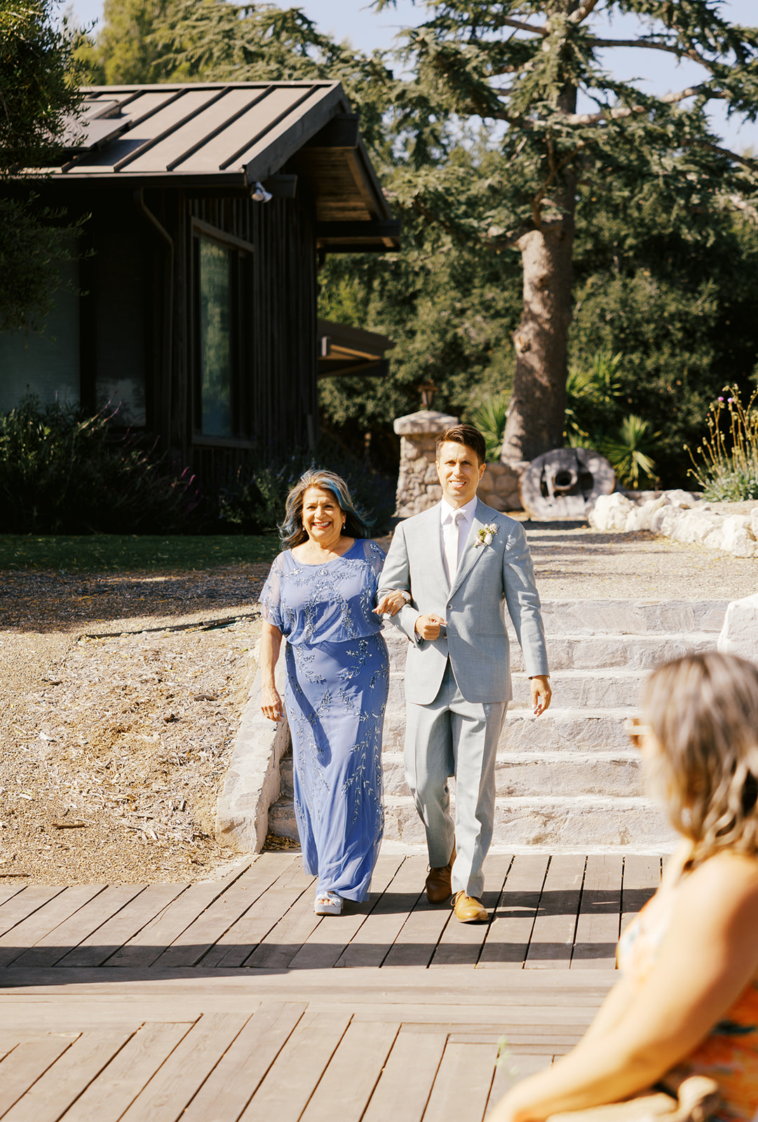 Damien walking to the ceremony with his mother