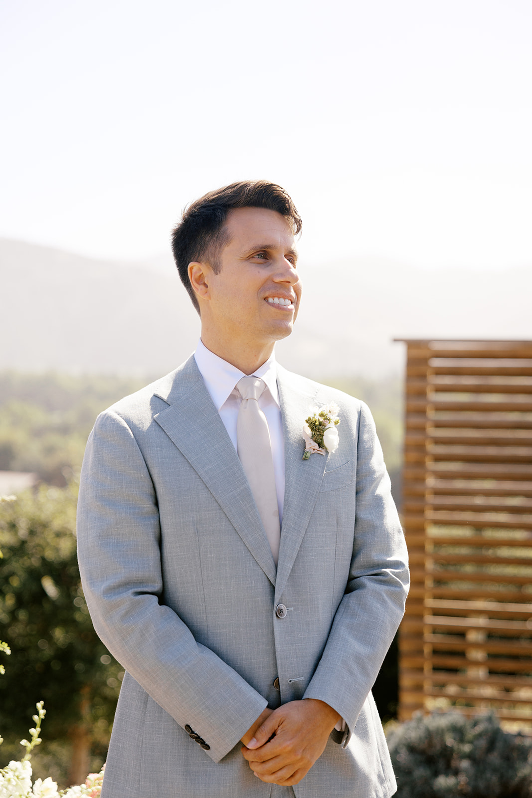 Damien smiling as he waits for Rachel at the ceremony