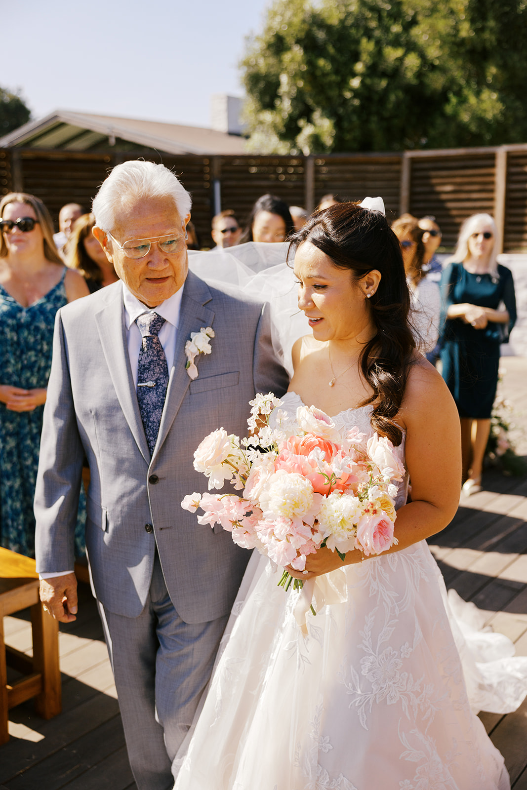 Rachel walking down the aisle with her father