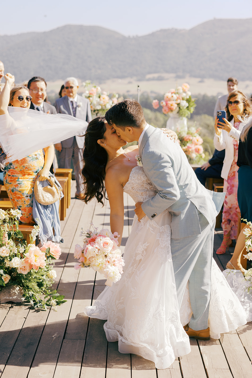 Rachel and Damien kissing in the aisle after their ceremony