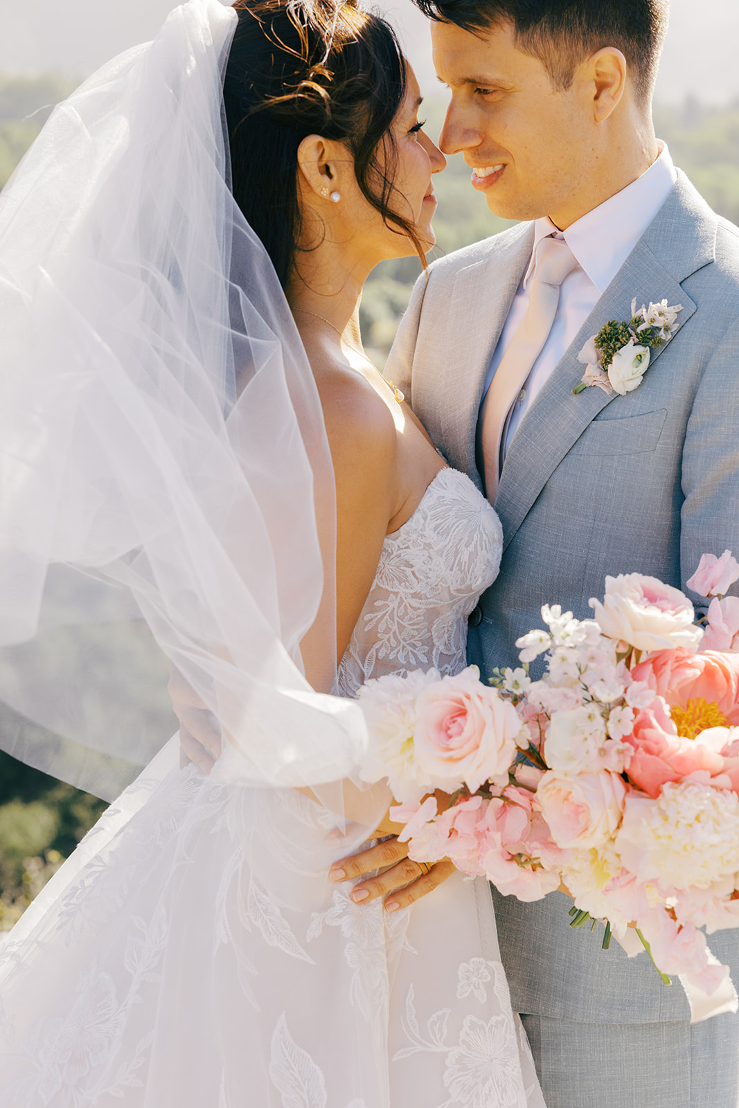Bridal bouquet and veil beside Damien’s blue suit