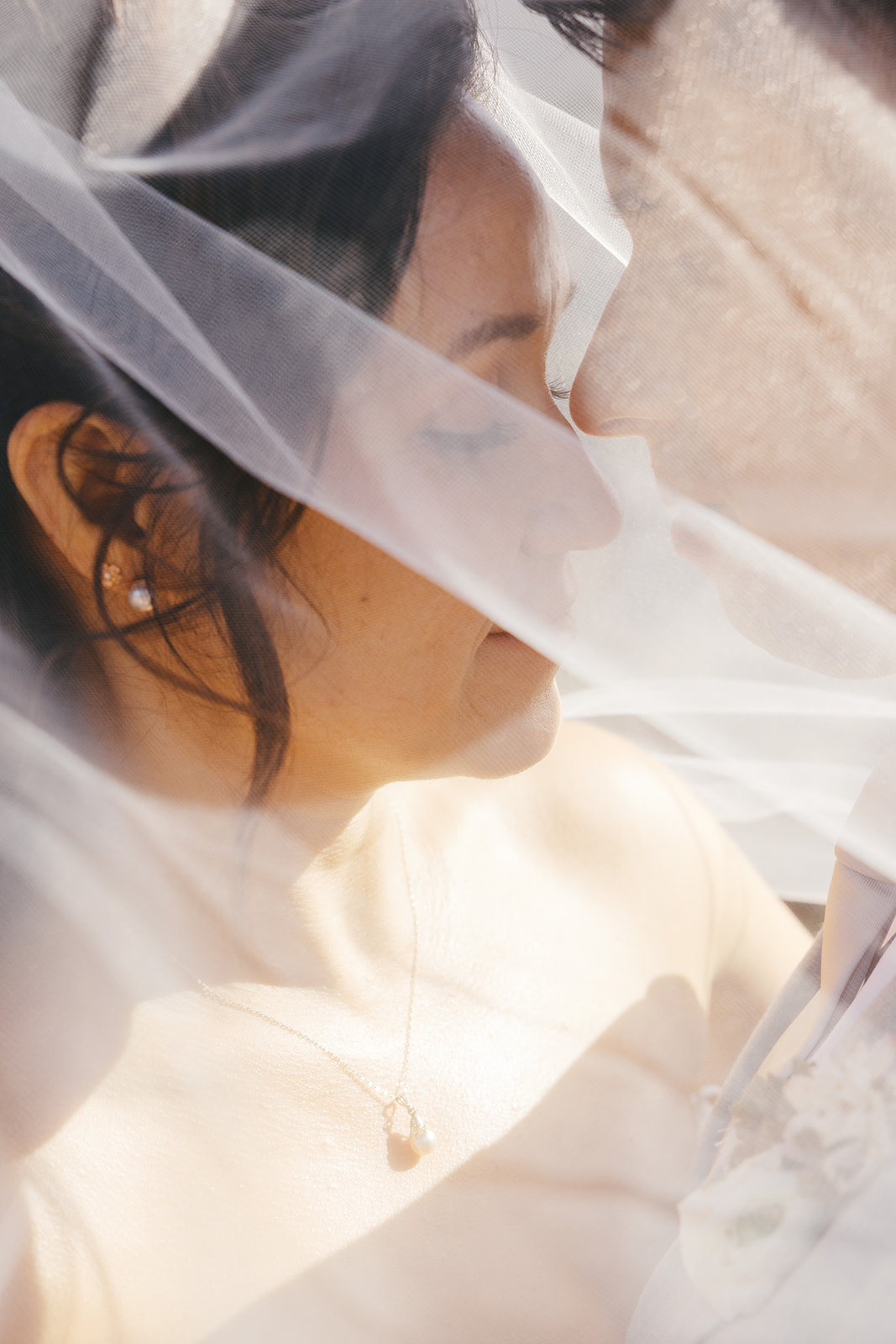 Soft close-up of Rachel beneath her bridal veil