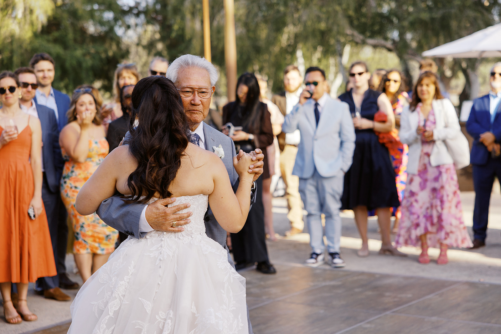 Rachel dancing with her father as guests watch