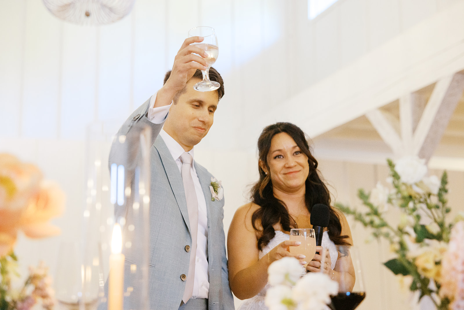 Rachel and Damien raising their glasses during the reception