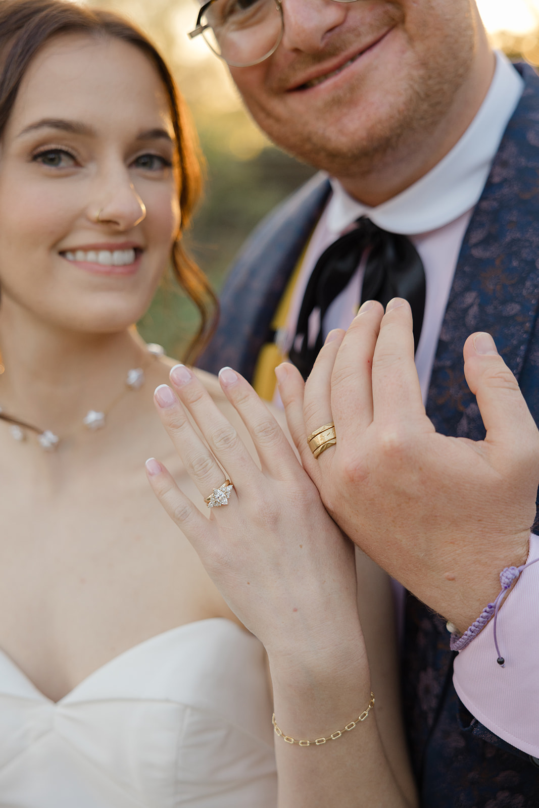 Jordan and Sara showing their wedding rings