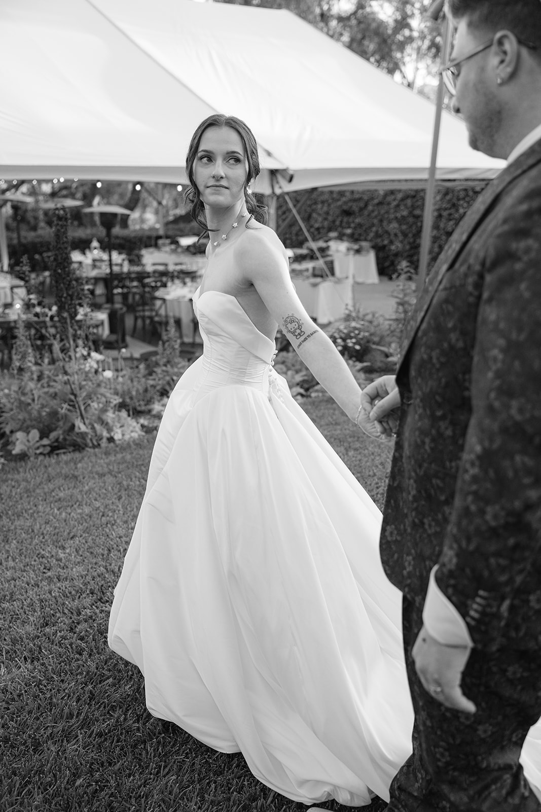 Black and white portrait of Sara holding Jordan’s hand