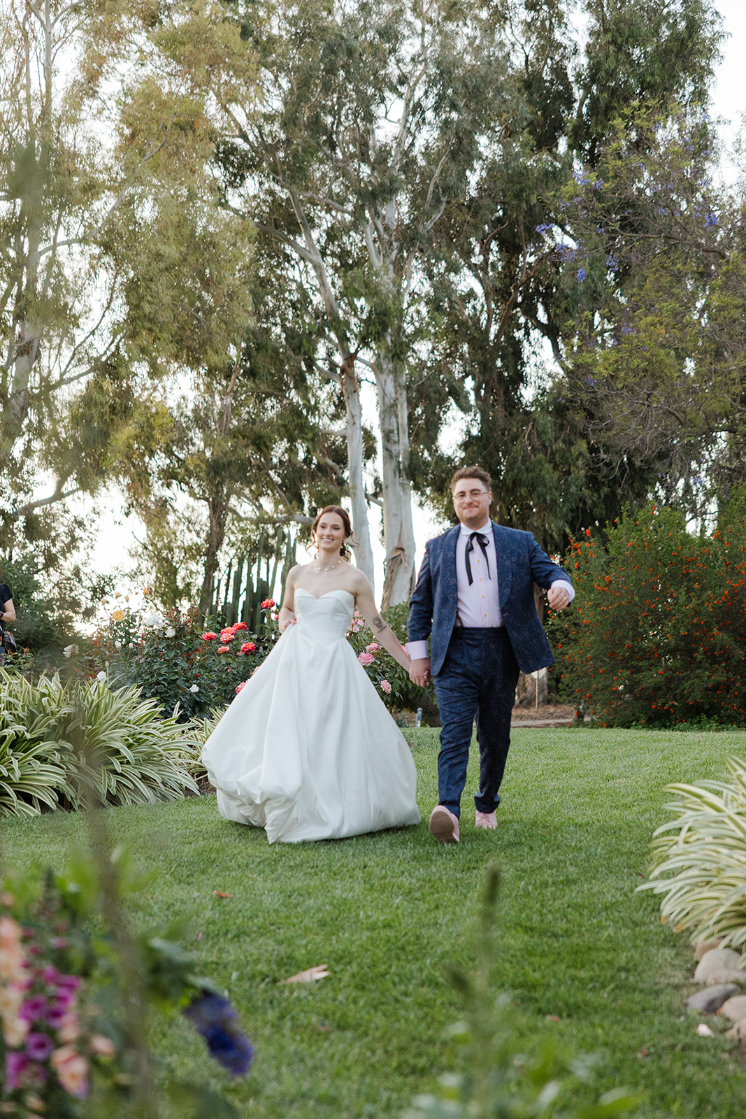 Jordan and Sara entering their garden wedding reception