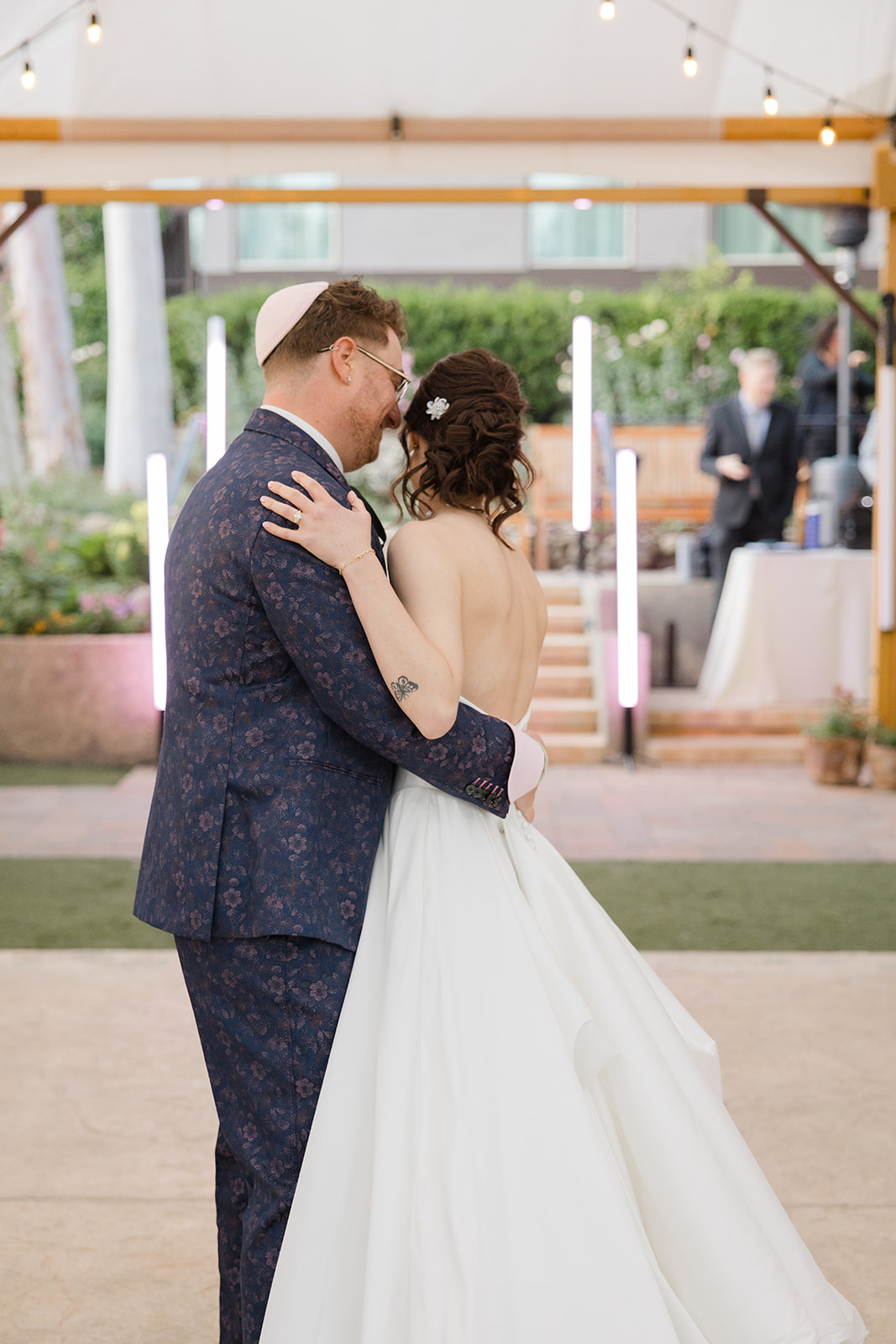 Jordan and Sara embracing during their first dance