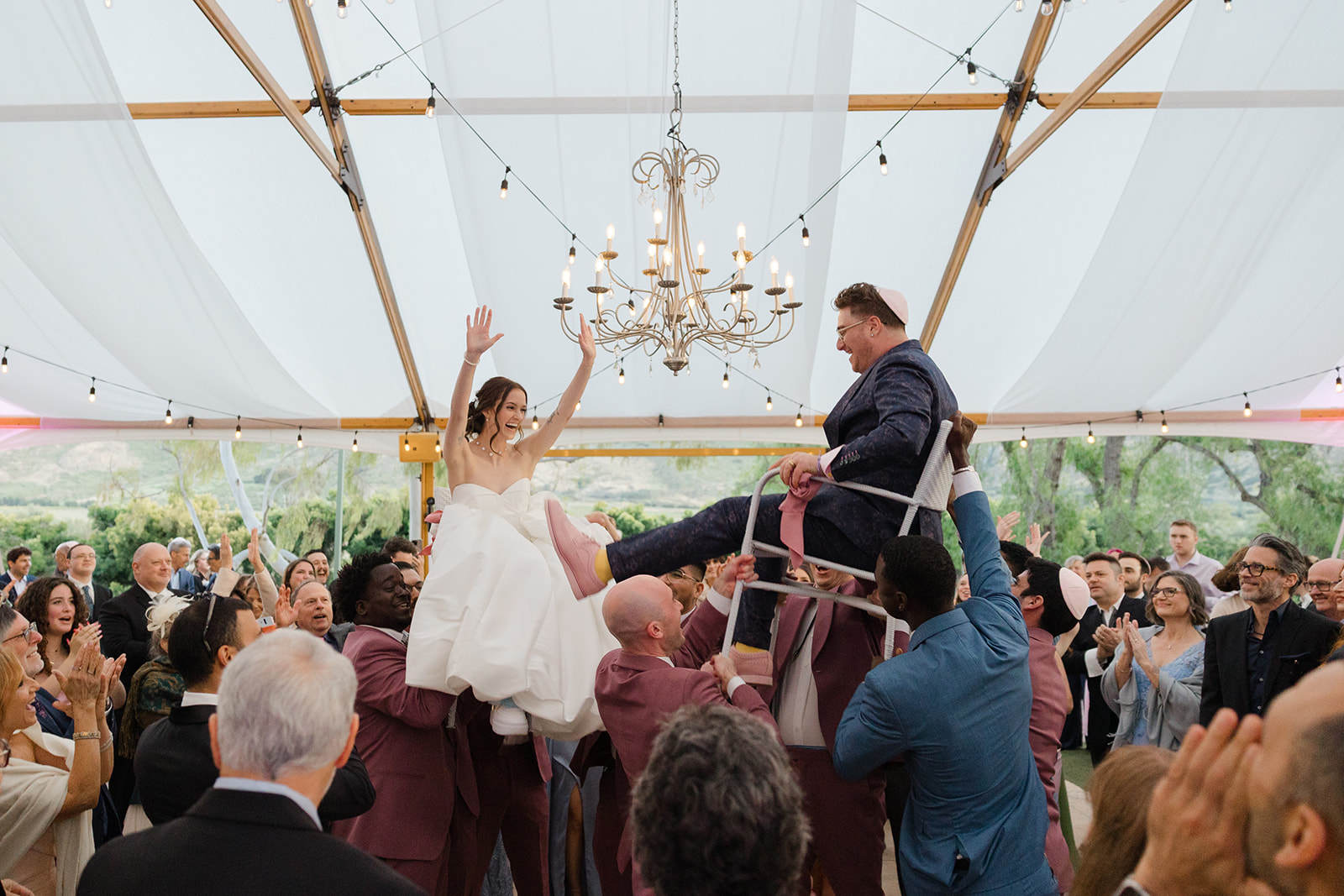 Jordan and Sara lifted on chairs during the hora