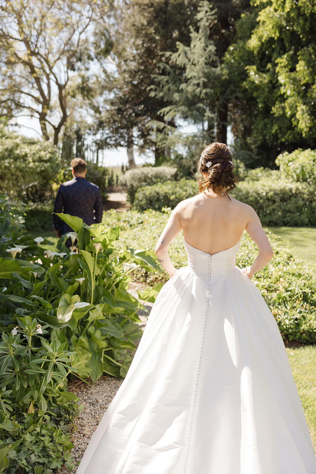 Sara walking toward Jordan through the garden
