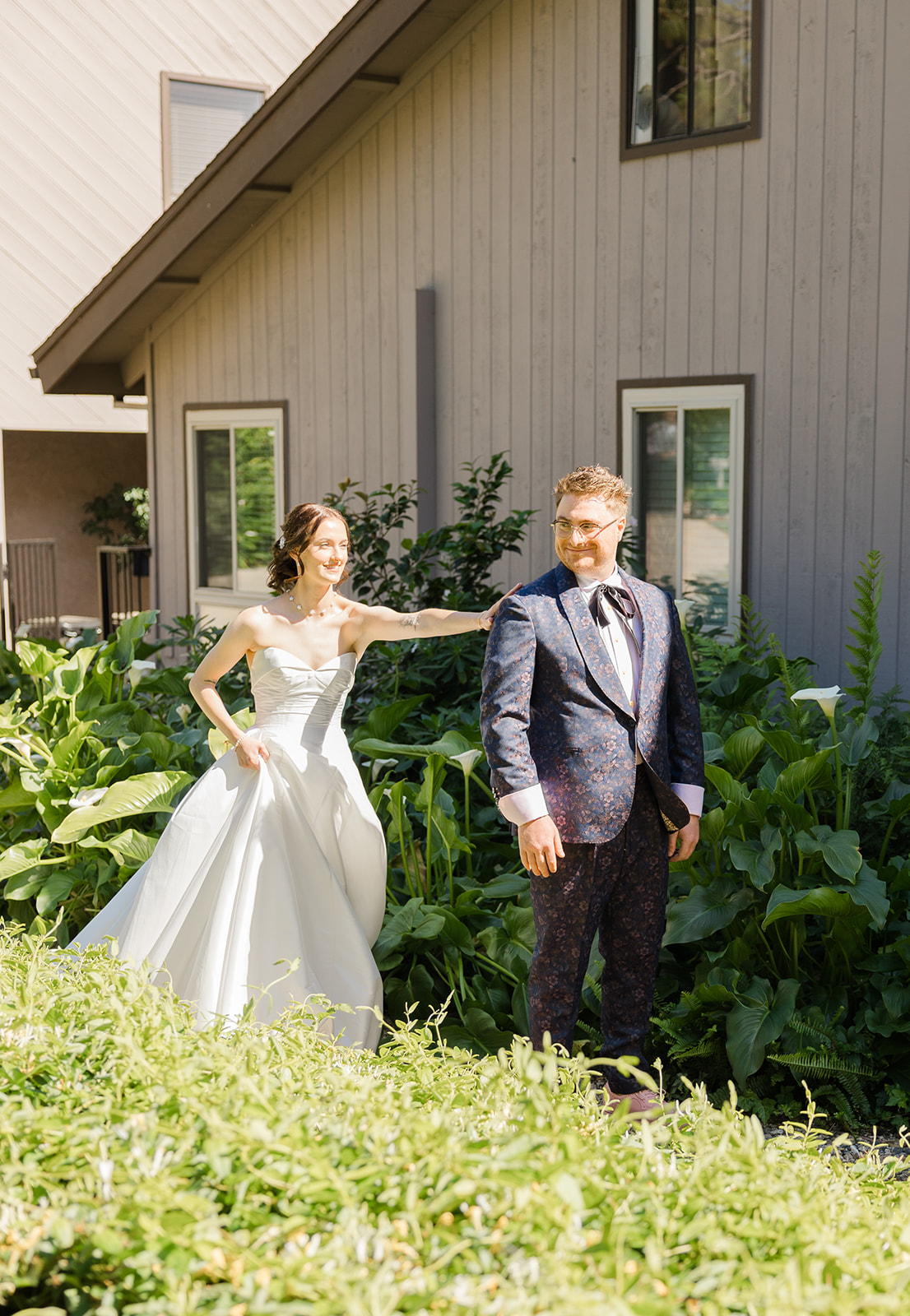 Sara approaching Jordan beside the garden cottage for their first look