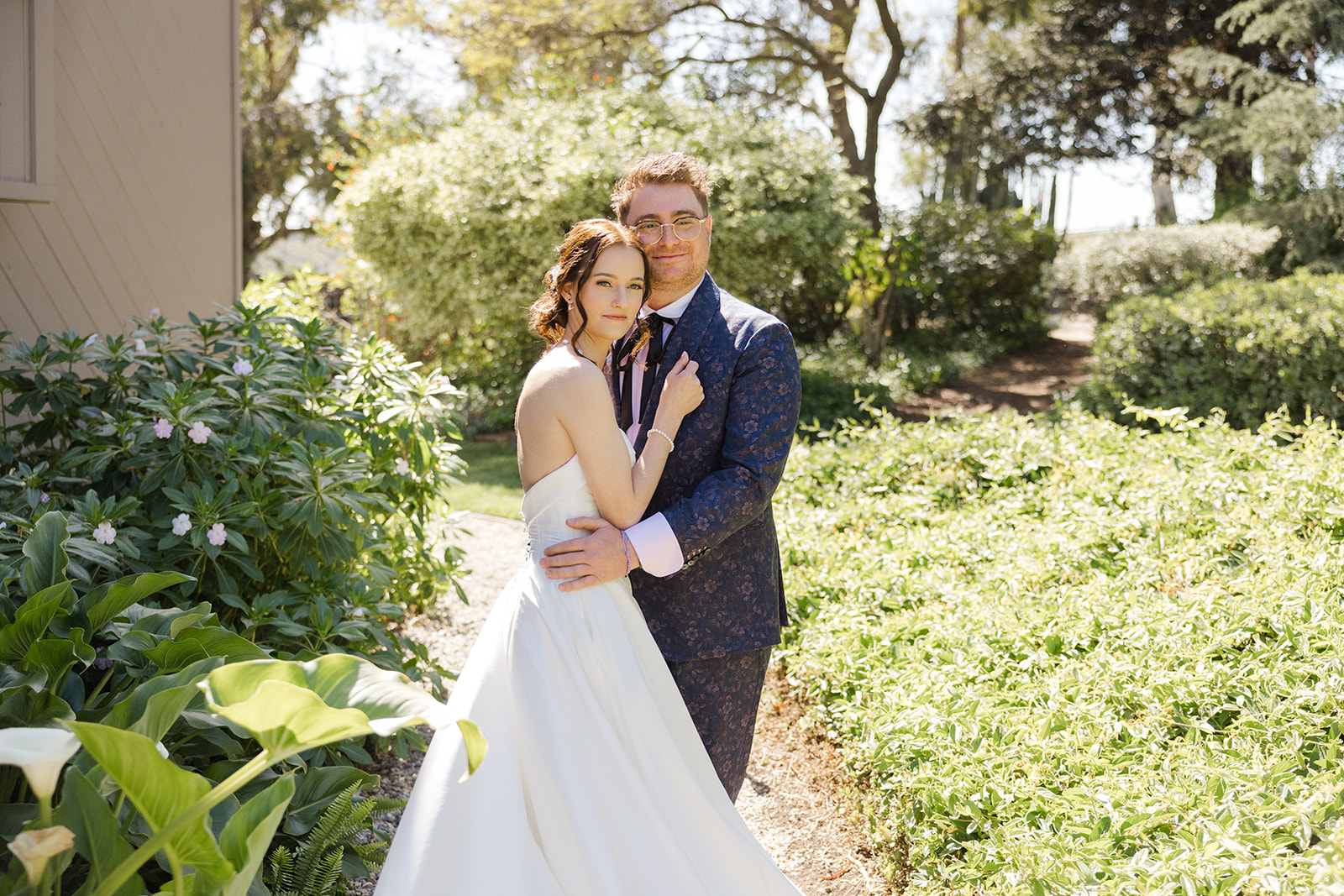 Wide portrait of Jordan and Sara beside the garden cottage