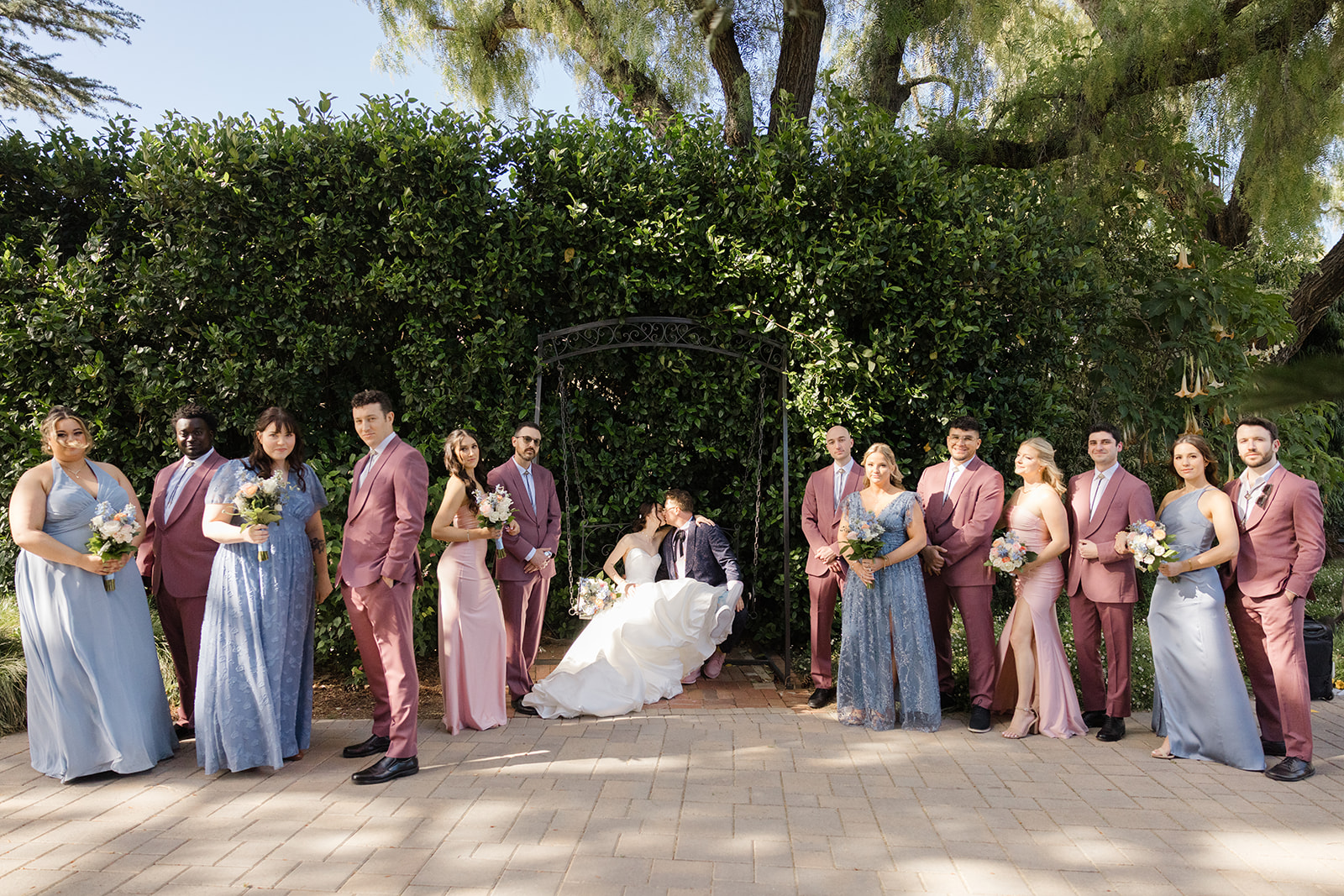 Wedding party gathered around Jordan and Sara at Maravilla Gardens
