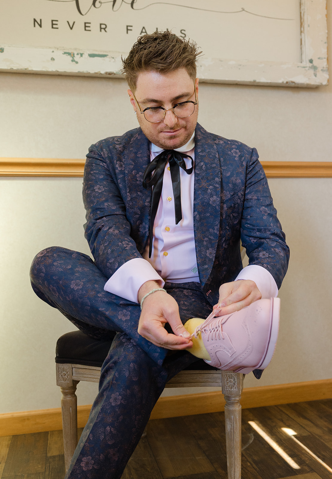 Jordan tying his pale pink wedding shoes