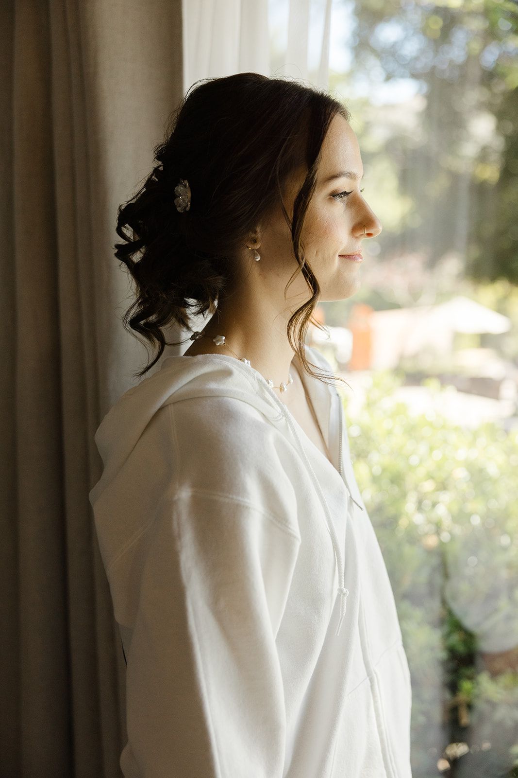 Sara standing beside the bridal room window before getting dressed