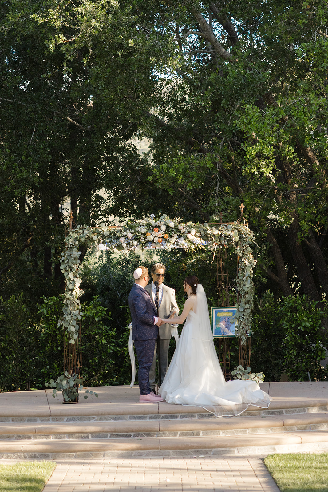 Garden wedding ceremony framed by trees at Maravilla Gardens