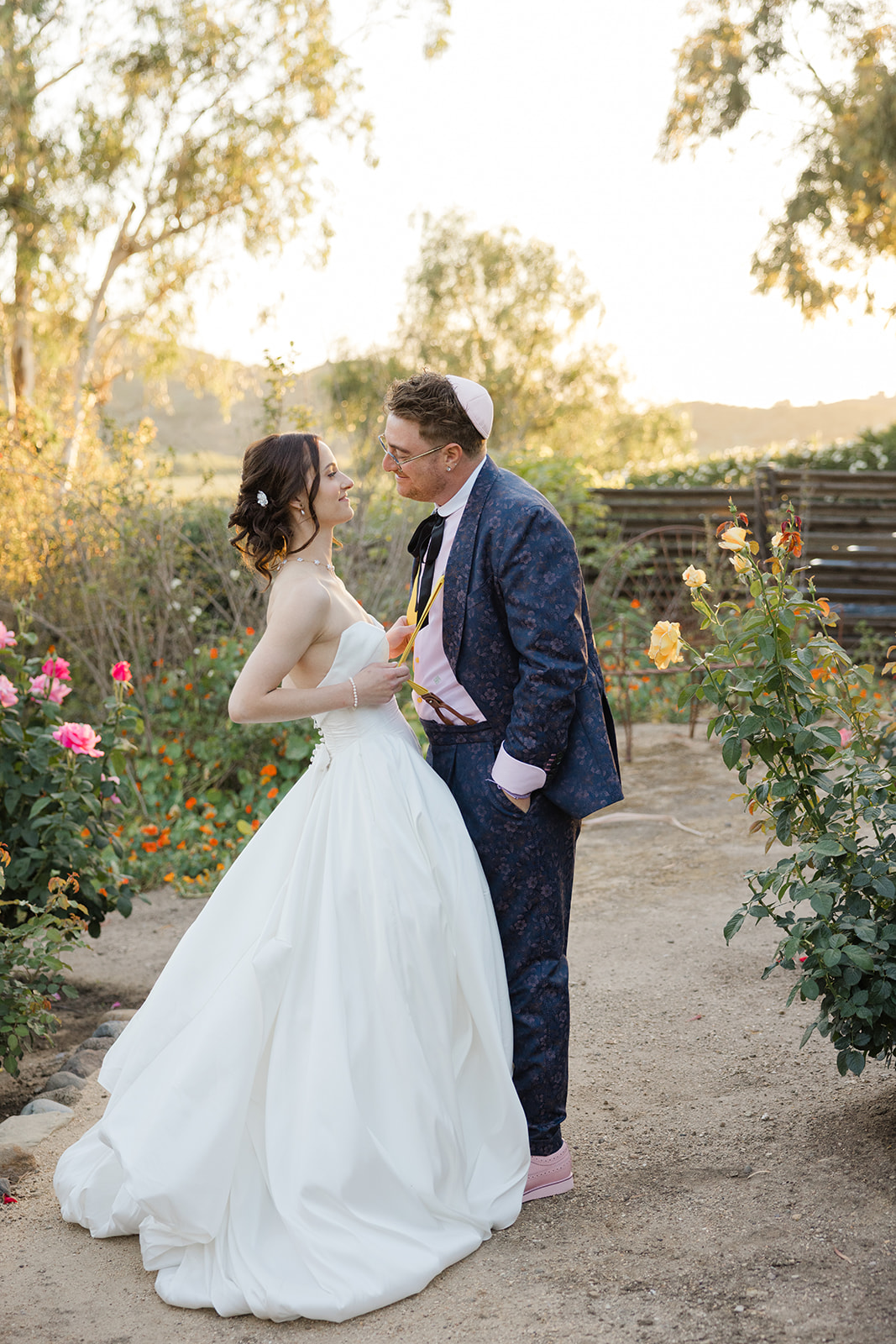 Jordan and Sara together on a path through the rose garden