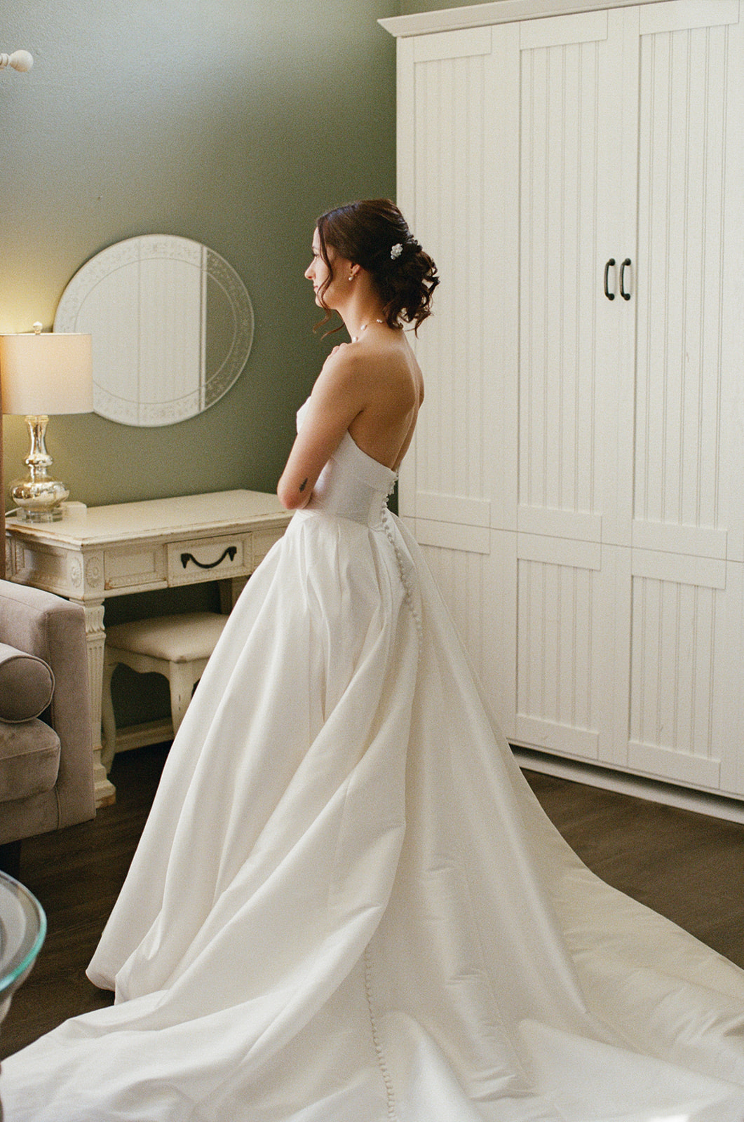 Film bridal portrait showing the back of Sara’s gown