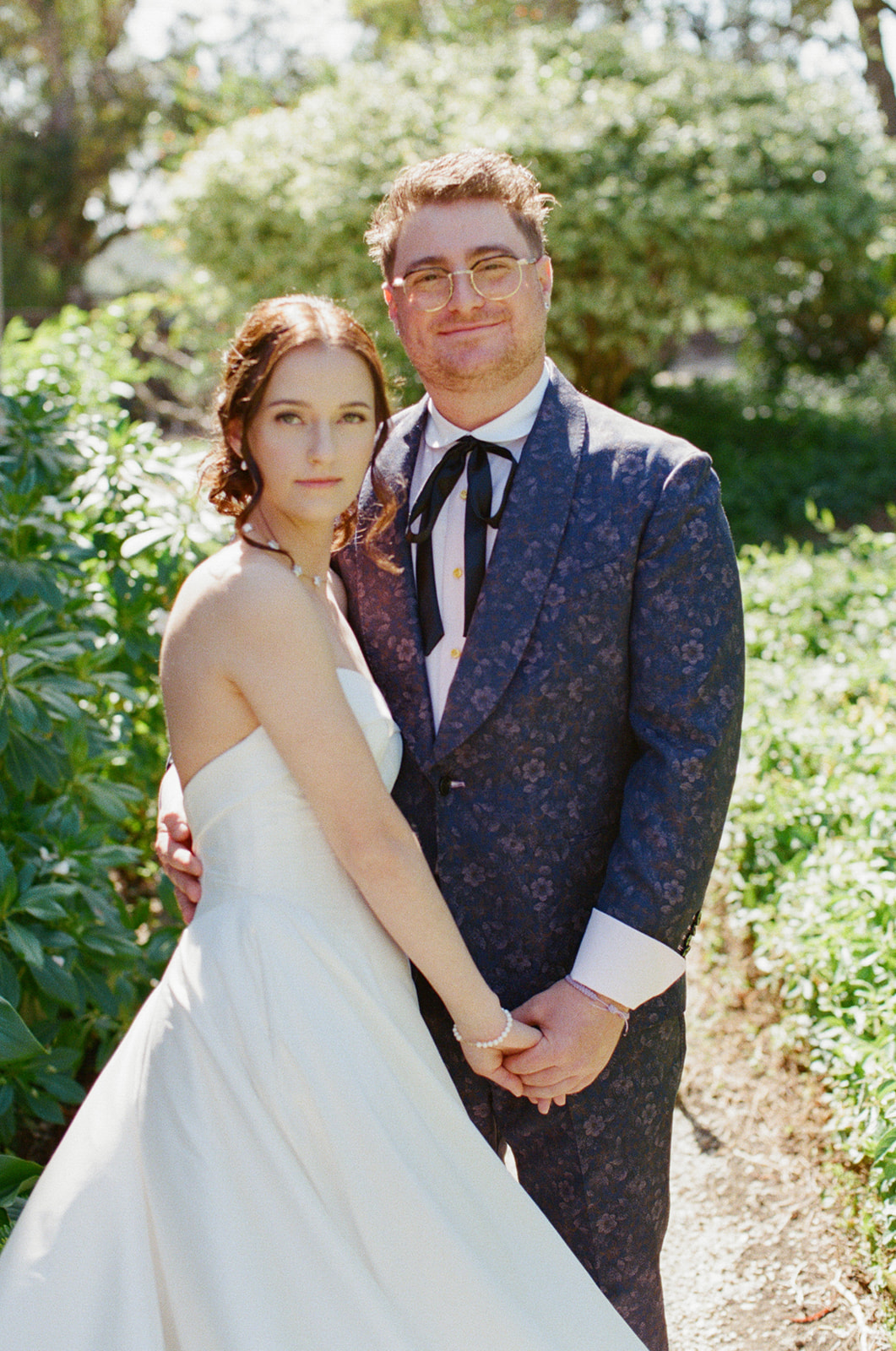 Film portrait of Jordan and Sara surrounded by greenery