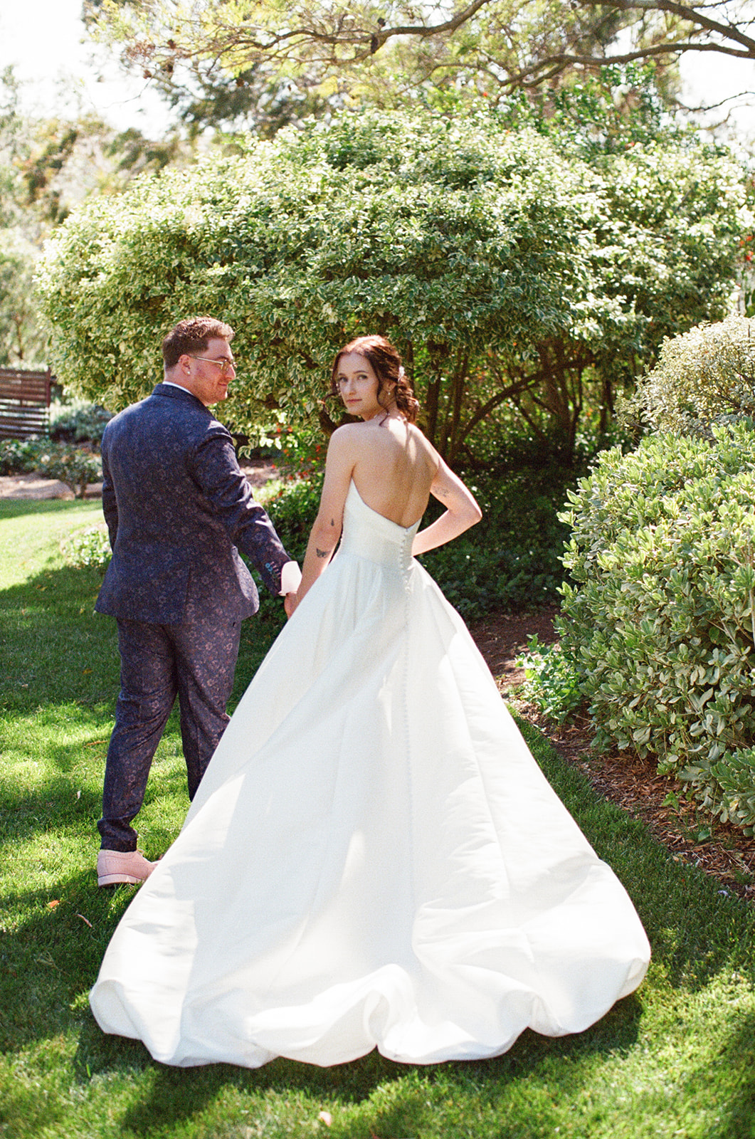 Film photograph of Jordan and Sara turning together on the lawn
