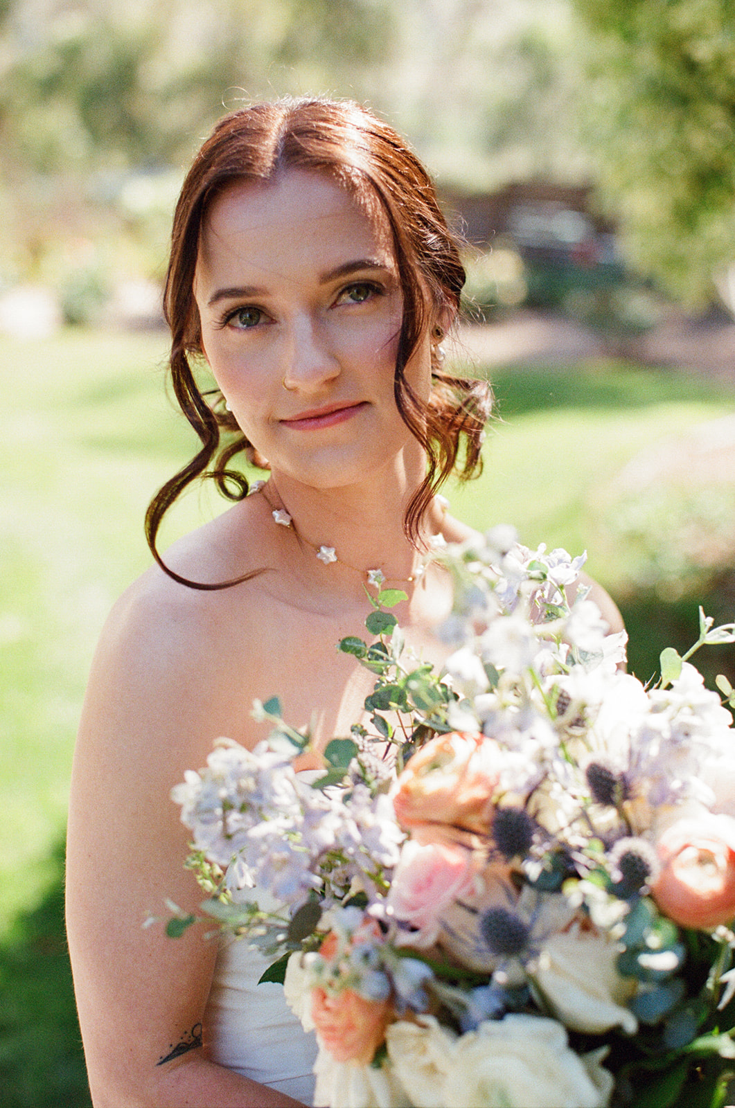 Film bridal portrait of Sara holding her spring bouquet
